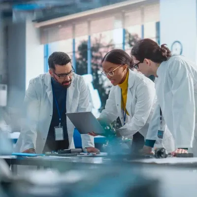 Three-scientists-looking-at-a-screen-400x400